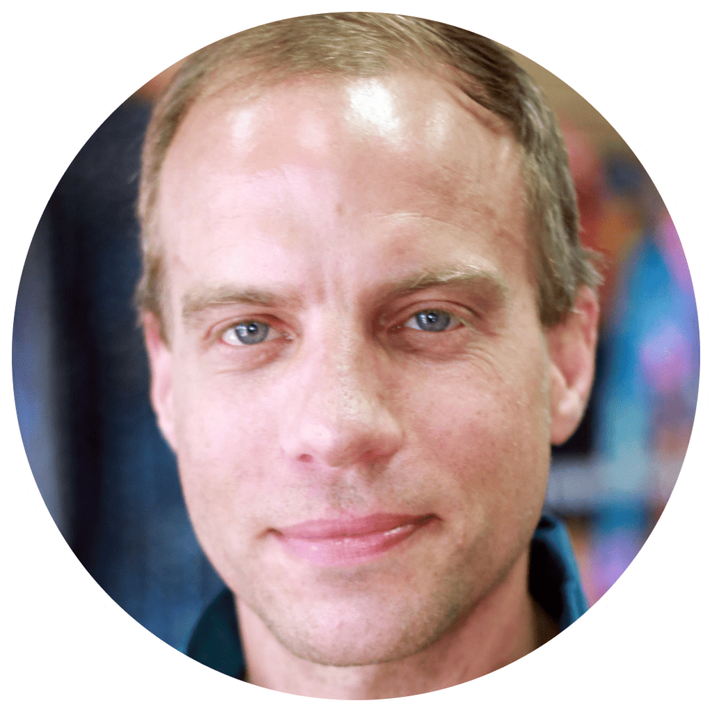 Portrait of a man with blue eyes, inside a white circle.