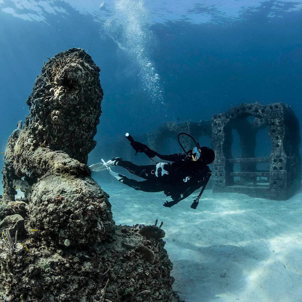 Underwater diver exploring Nova 850 Tec 05 reef structures.
